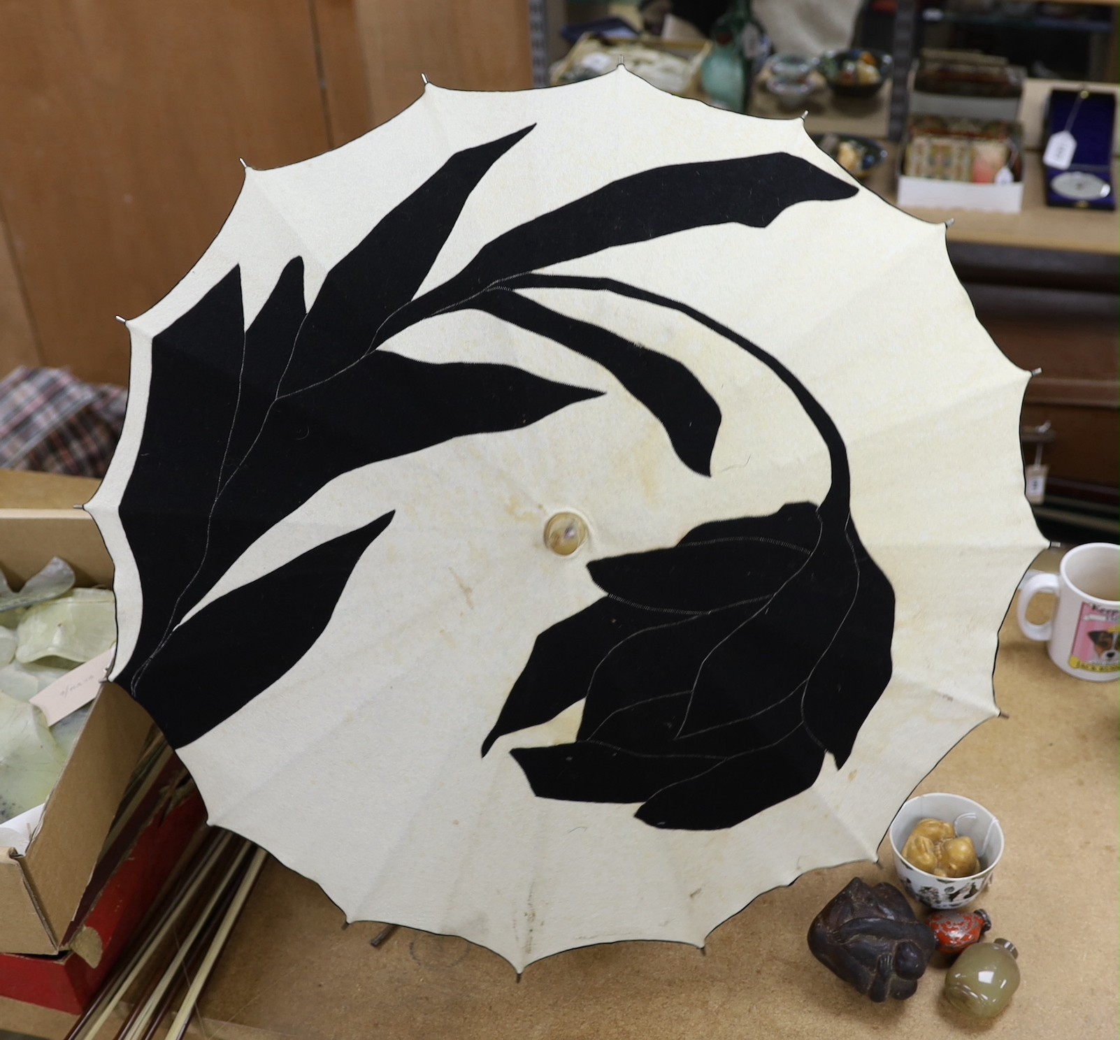 An unusual Japanese designed Art Deco cream and black felt parasol, with a horn and hammered metal handle